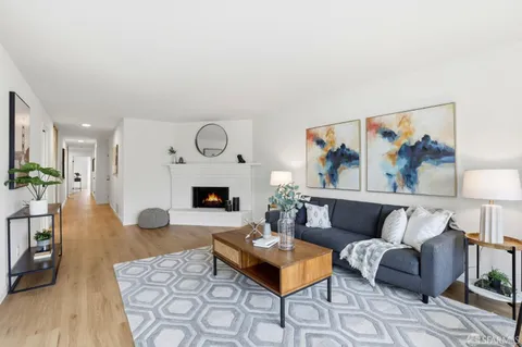 a living room with furniture a rug and a fireplace