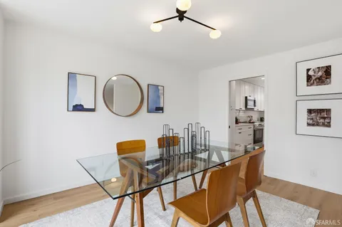 a dining room with furniture and a mirror