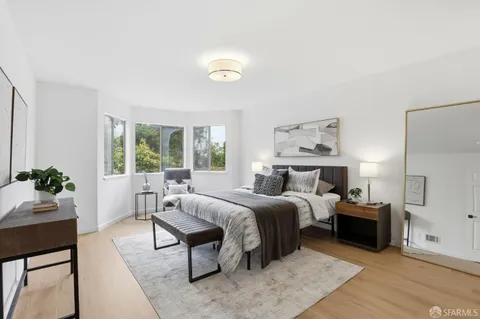 a bedroom with a large bed and a window