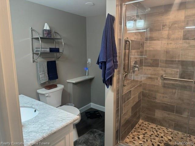 1467 Krafft Road, Unit 8 Port Huron, MI 48060 - Photo 28 of 28 Walk-in shower with wood-finish tile surround and natural stone pebble floor