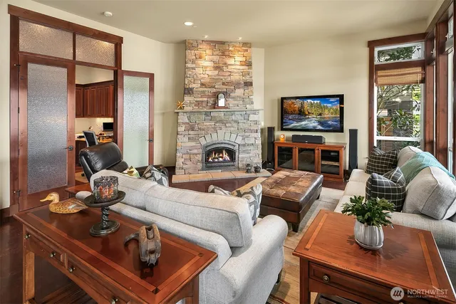 a living room with furniture fireplace and flat screen tv
