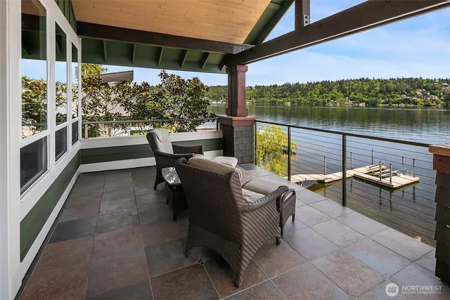 a view of a chairs and table in patio with a lake view