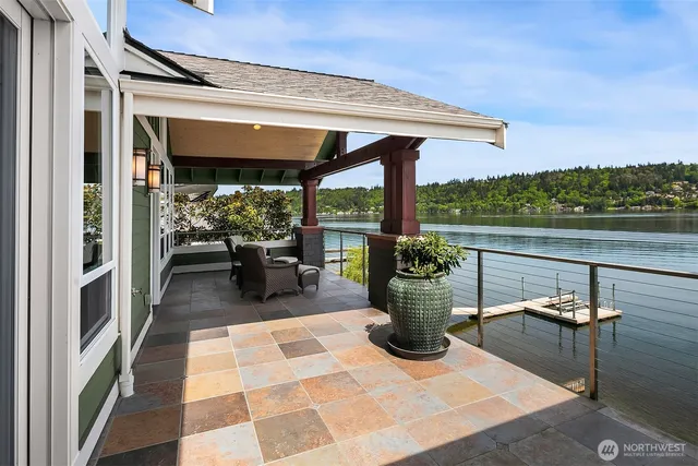 a view of a chairs and table in the balcony