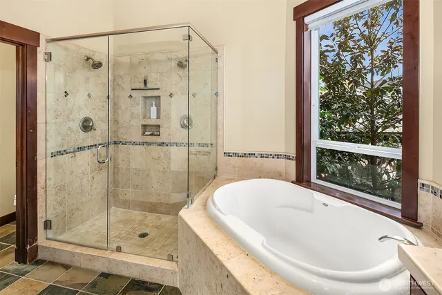a bathroom with a bathtub and shower