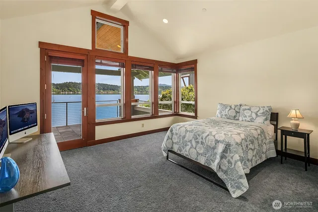 a spacious bedroom with a bed and a large window