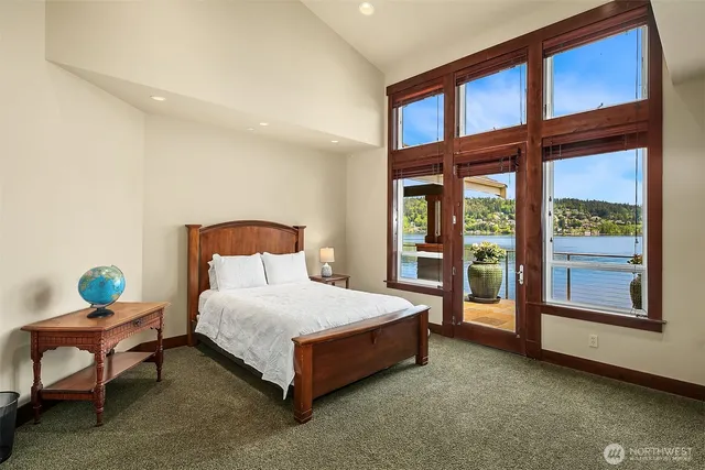 a spacious bedroom with a bed and glass window