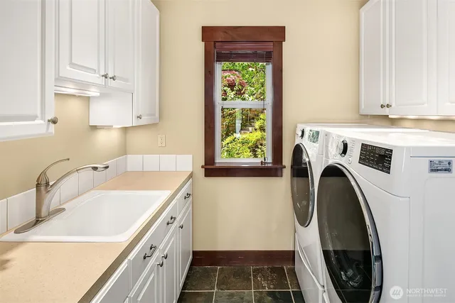a view of a kitchen with sink and washing machine