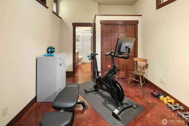 a room with gym equipment and windows