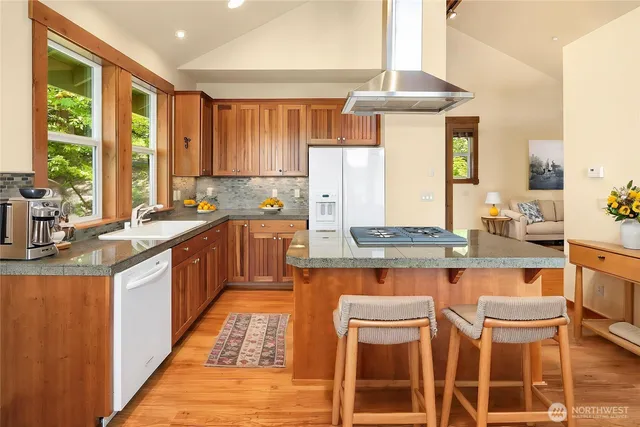a kitchen with a stove a sink and cabinets