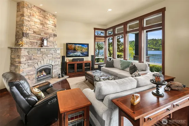 a living room with furniture a flat screen tv and a fireplace