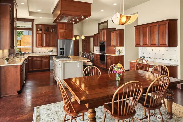 a dining room filled chandelier and wooden floor
