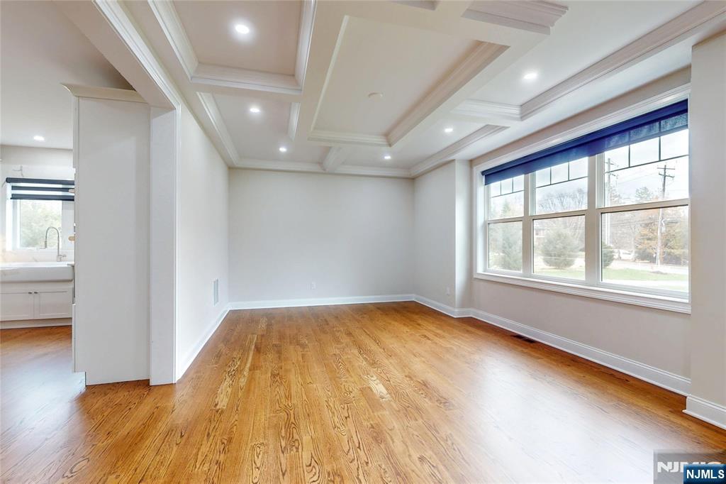 19 Meadowbrook Road Upper Saddle River, NJ 07458 - Photo 12 of 47 an empty room with wooden floor and windows