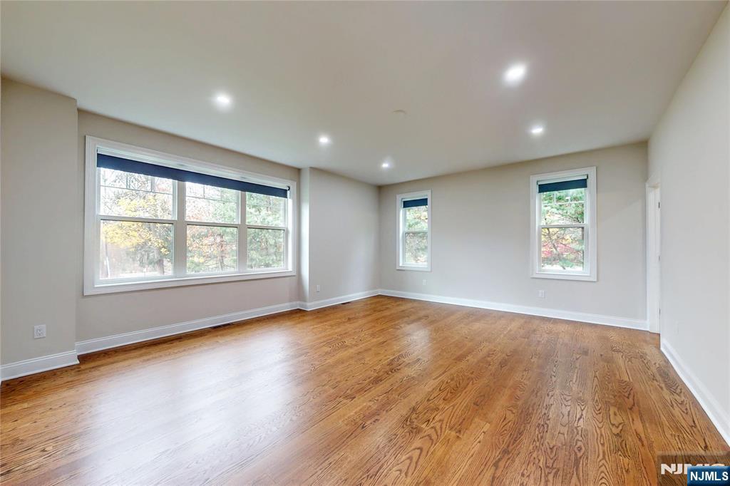 19 Meadowbrook Road Upper Saddle River, NJ 07458 - Photo 15 of 47 an empty room with wooden floor and windows