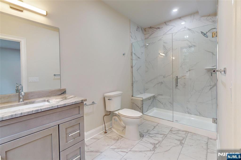 19 Meadowbrook Road Upper Saddle River, NJ 07458 - Photo 16 of 47 a bathroom with a granite countertop sink a toilet and a shower