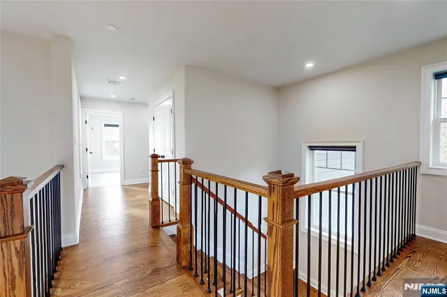a view of a hallway with windows and stairs