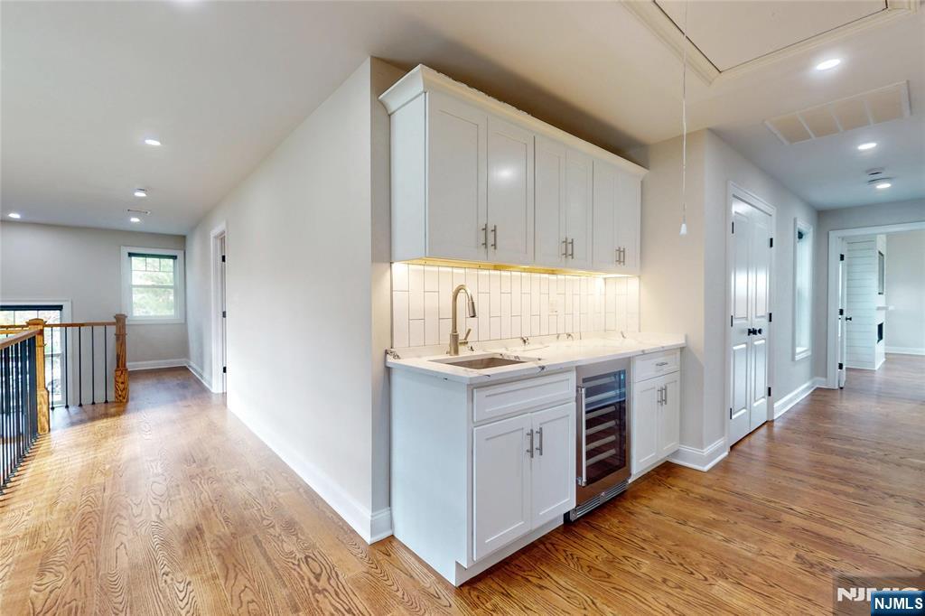 19 Meadowbrook Road Upper Saddle River, NJ 07458 - Photo 19 of 47 a kitchen with kitchen island white cabinets and stainless steel appliances