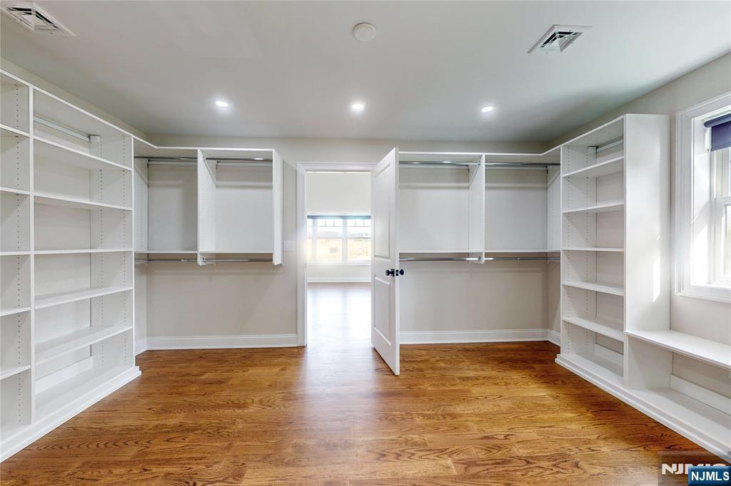 19 Meadowbrook Road Upper Saddle River, NJ 07458 - Photo 22 of 47 a view of an empty room with a cabinet and wooden floor