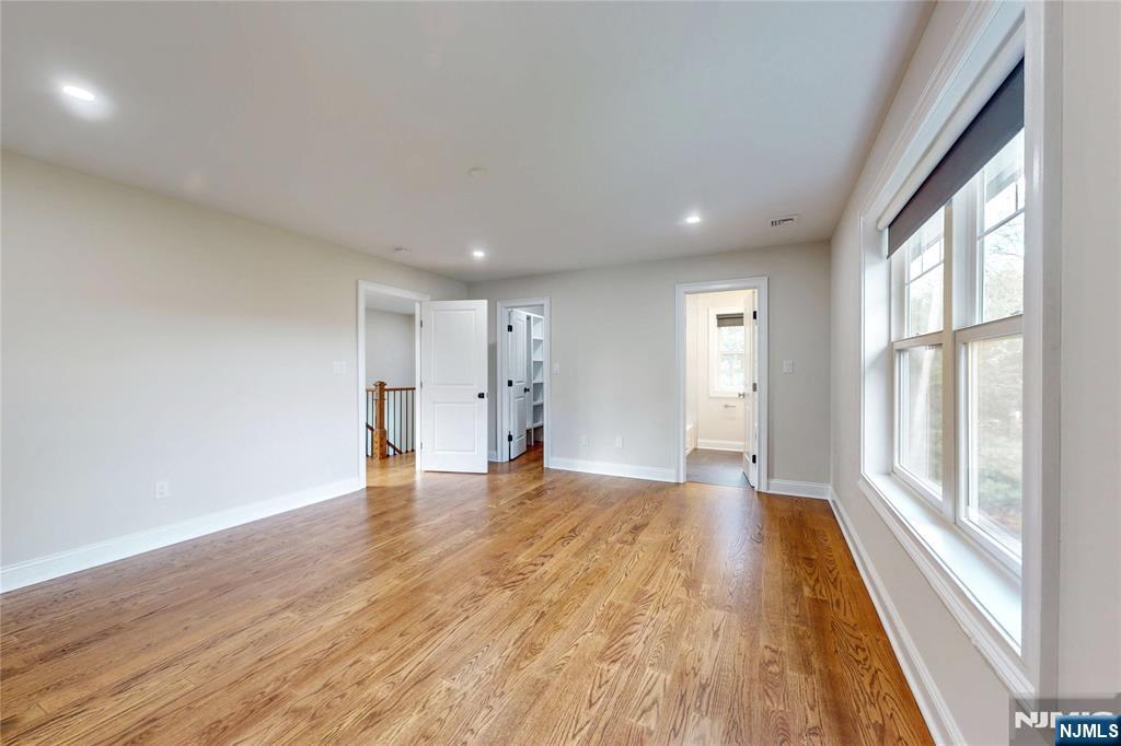 19 Meadowbrook Road Upper Saddle River, NJ 07458 - Photo 31 of 47 a view of empty room with wooden floor and fan