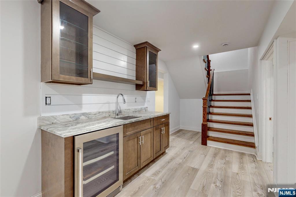 19 Meadowbrook Road Upper Saddle River, NJ 07458 - Photo 37 of 47 a kitchen with a sink and a wooden floor