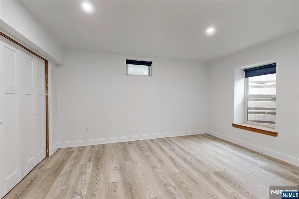 19 Meadowbrook Road Upper Saddle River, NJ 07458 - Photo 40 of 47 wooden floor in an empty room with a window