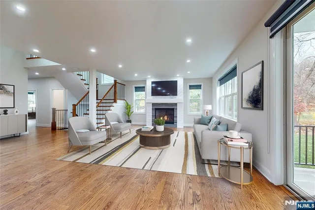 a living room with furniture a fireplace and a flat screen tv