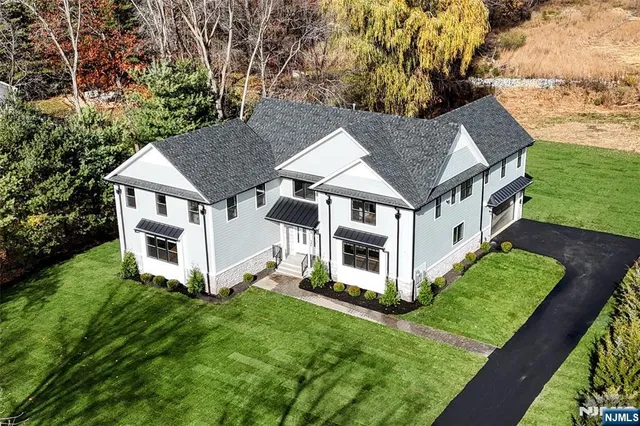 a aerial view of a house with a yard table and chairs