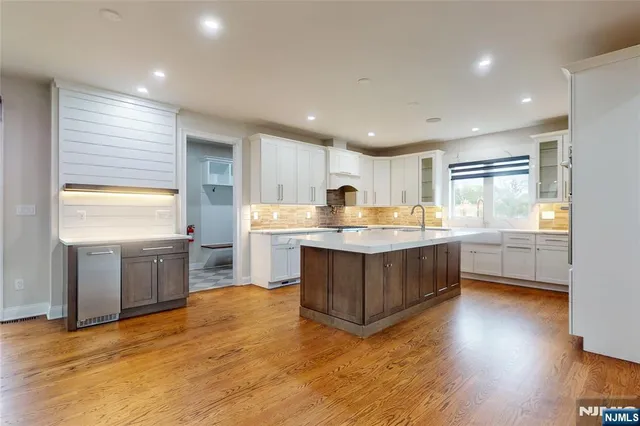 a kitchen with a refrigerator sink and cabinets