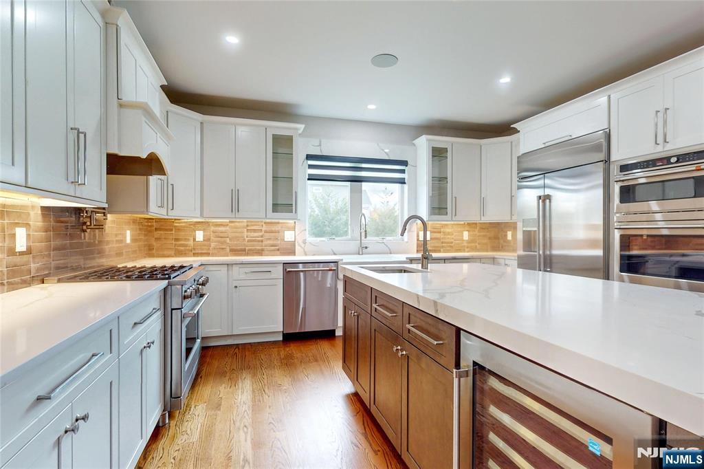 19 Meadowbrook Road Upper Saddle River, NJ 07458 - Photo 6 of 47 a kitchen with stainless steel appliances granite countertop a sink stove and refrigerator