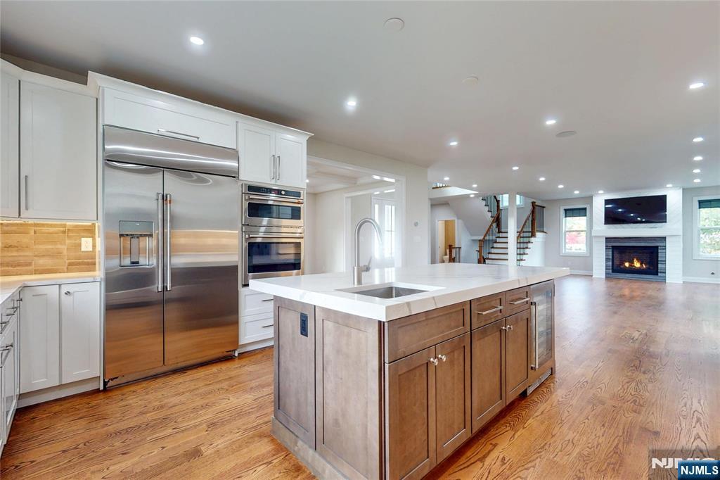 19 Meadowbrook Road Upper Saddle River, NJ 07458 - Photo 8 of 47 a kitchen with stainless steel appliances granite countertop a refrigerator and a stove top oven