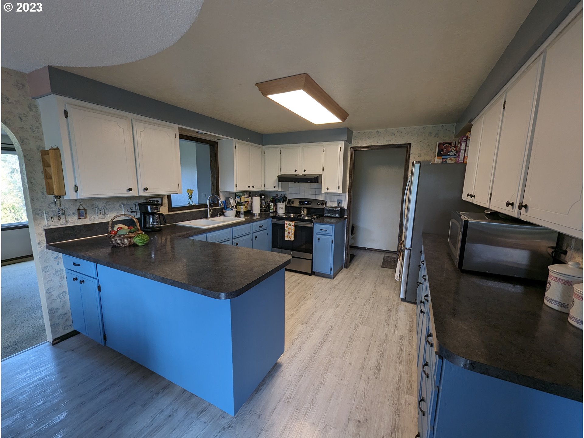 17600 Shady Lane Road Monmouth, OR 97361 - Photo 13 of 44 a kitchen with stainless steel appliances granite countertop a refrigerator a stove and a sink