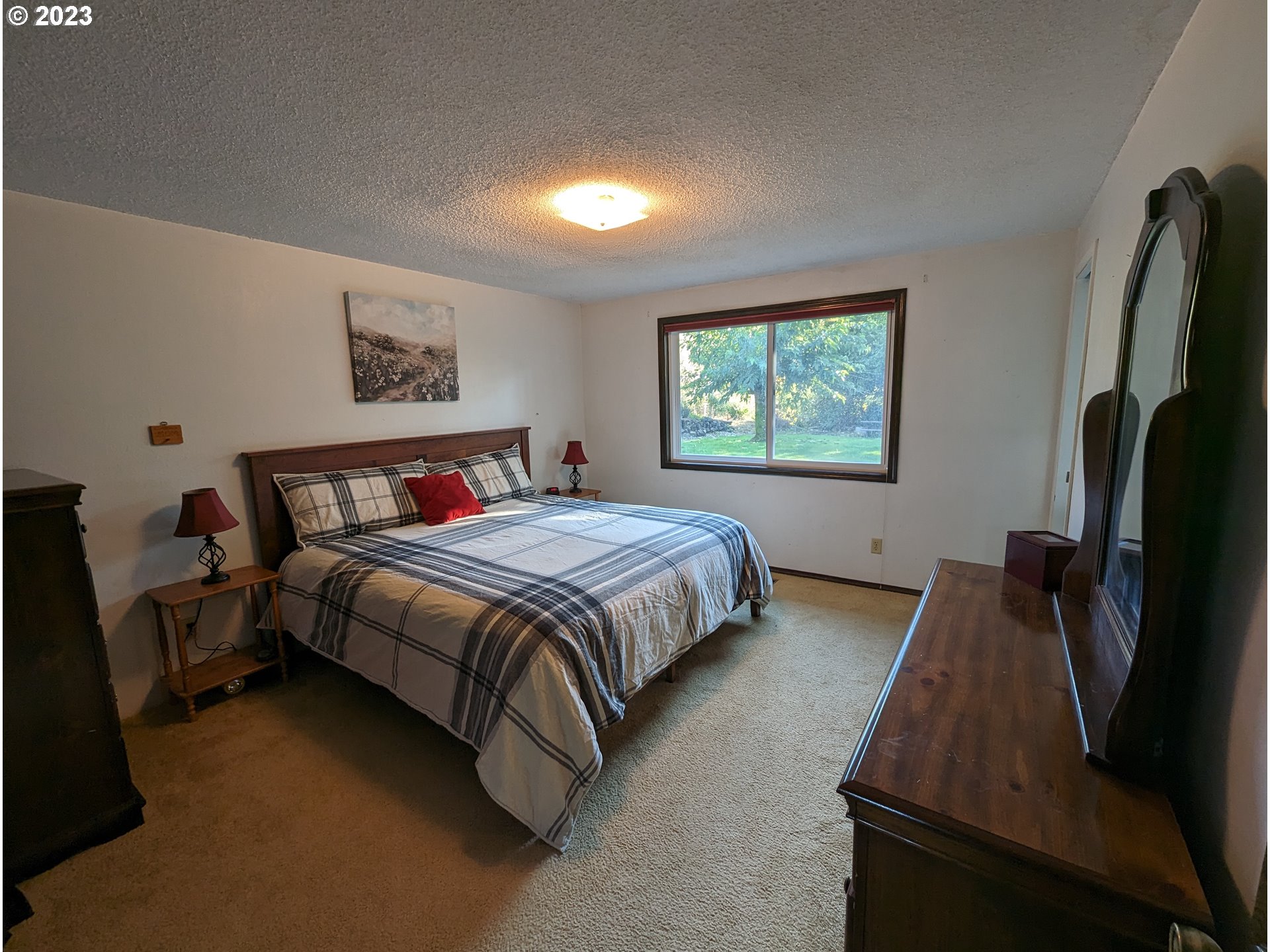 17600 Shady Lane Road Monmouth, OR 97361 - Photo 20 of 44 a spacious bedroom with a bed and a flat screen tv