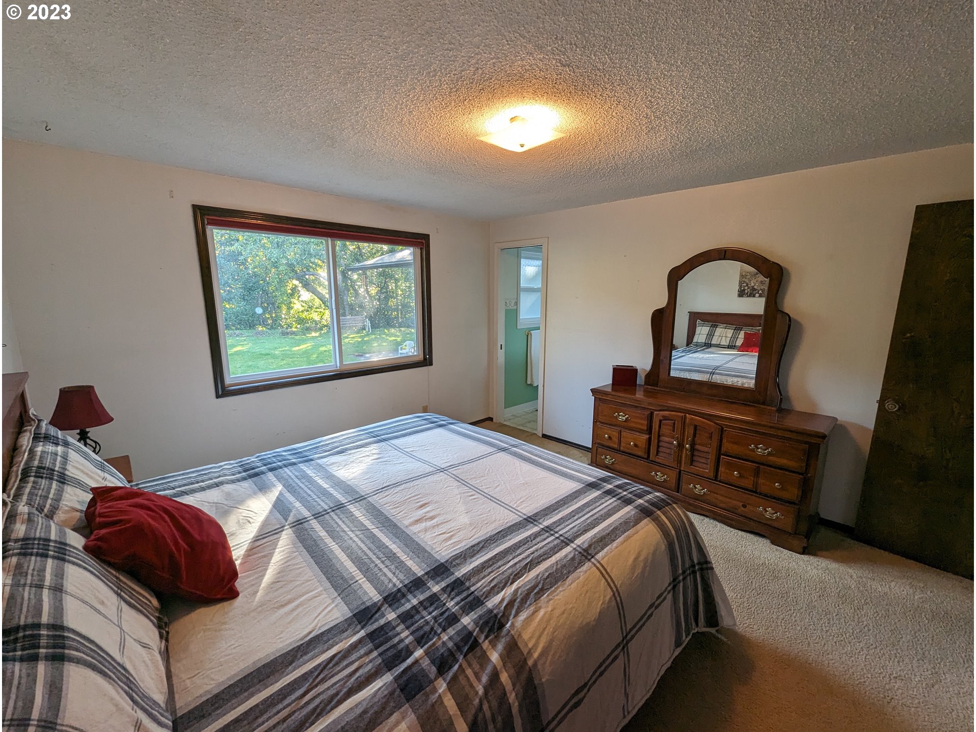 17600 Shady Lane Road Monmouth, OR 97361 - Photo 21 of 44 a bedroom with a bed and a dresser next to a window