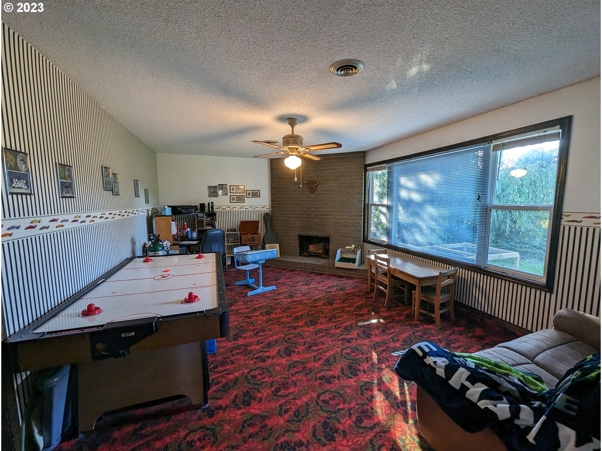 17600 Shady Lane Road Monmouth, OR 97361 - Photo 24 of 44 a living room with furniture a flat screen tv and a large window