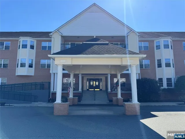 a view of a building with sitting area and garden
