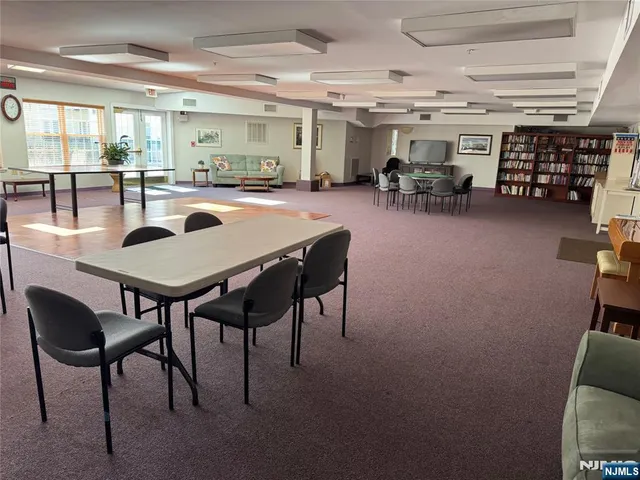 a kitchen with stainless steel appliances granite countertop white cabinets stove a refrigerator a sink and dishwasher