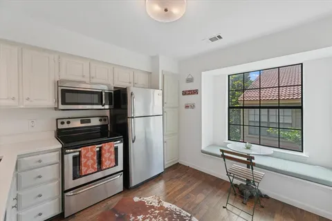 a kitchen with appliances and cabinets