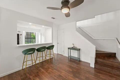 a view of a livingroom with furniture and hardwood floor