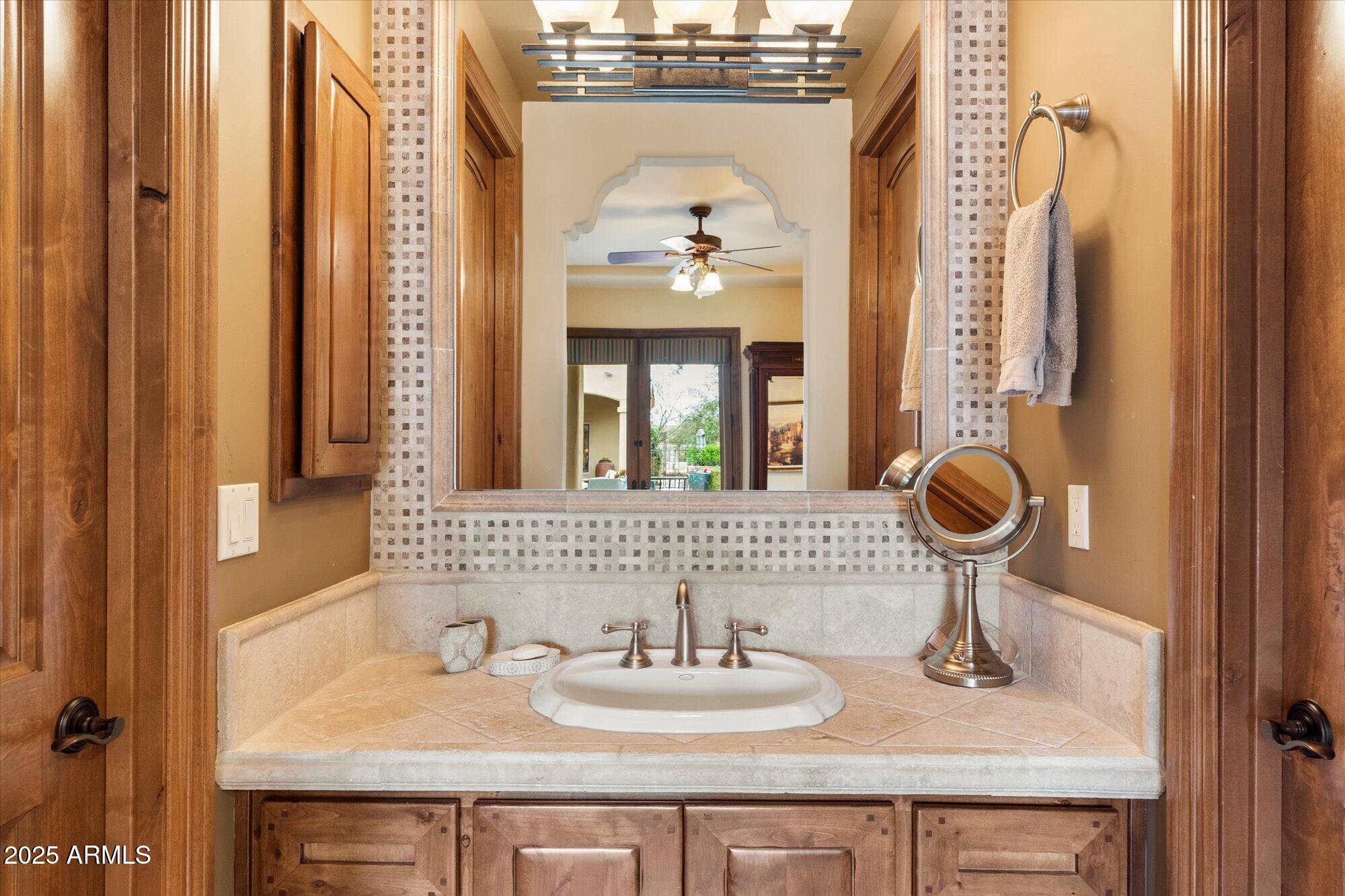 6402 East Chaparral Road Paradise Valley, AZ 85253 - Photo 64 of 125 a bathroom with a sink and a mirror