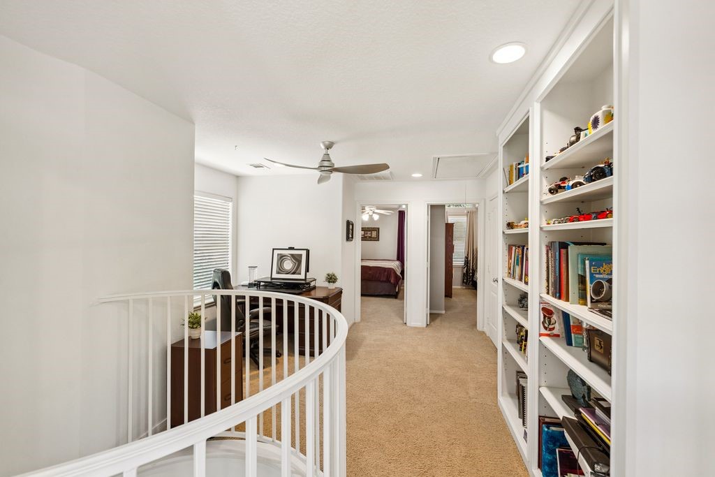 1607 Schooner Point Willis, TX 77318 - Photo 19 of 47 From top of stairs, this direction leads to the wall of bookshelves, Loft study area, 2 secondary bedrooms and another full bathroom. The curved railing opens like a rotunda to the 1st floor.