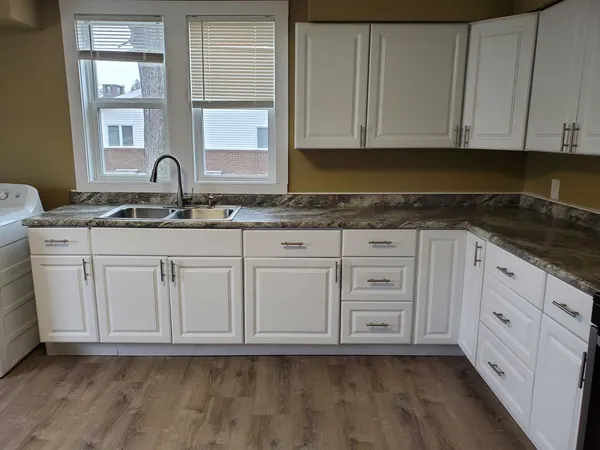 a view of granite countertop white cabinets and sink