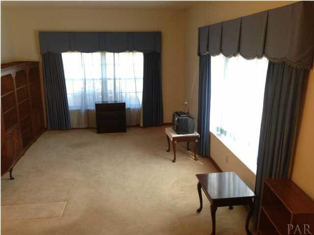 7495 Gunter Road Pensacola, FL 32526 - Photo 10 of 25 Large windows let in a lot of natural light into the living and dining rooms.