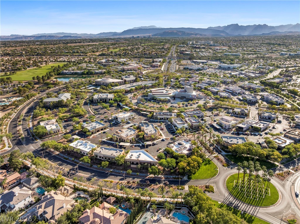 2000 Grouse Street Las Vegas, NV 89134 - Photo 71 of 89 An aerial perspective reveals a vibrant community with commercial buildings, residences, and scenic natural elements.