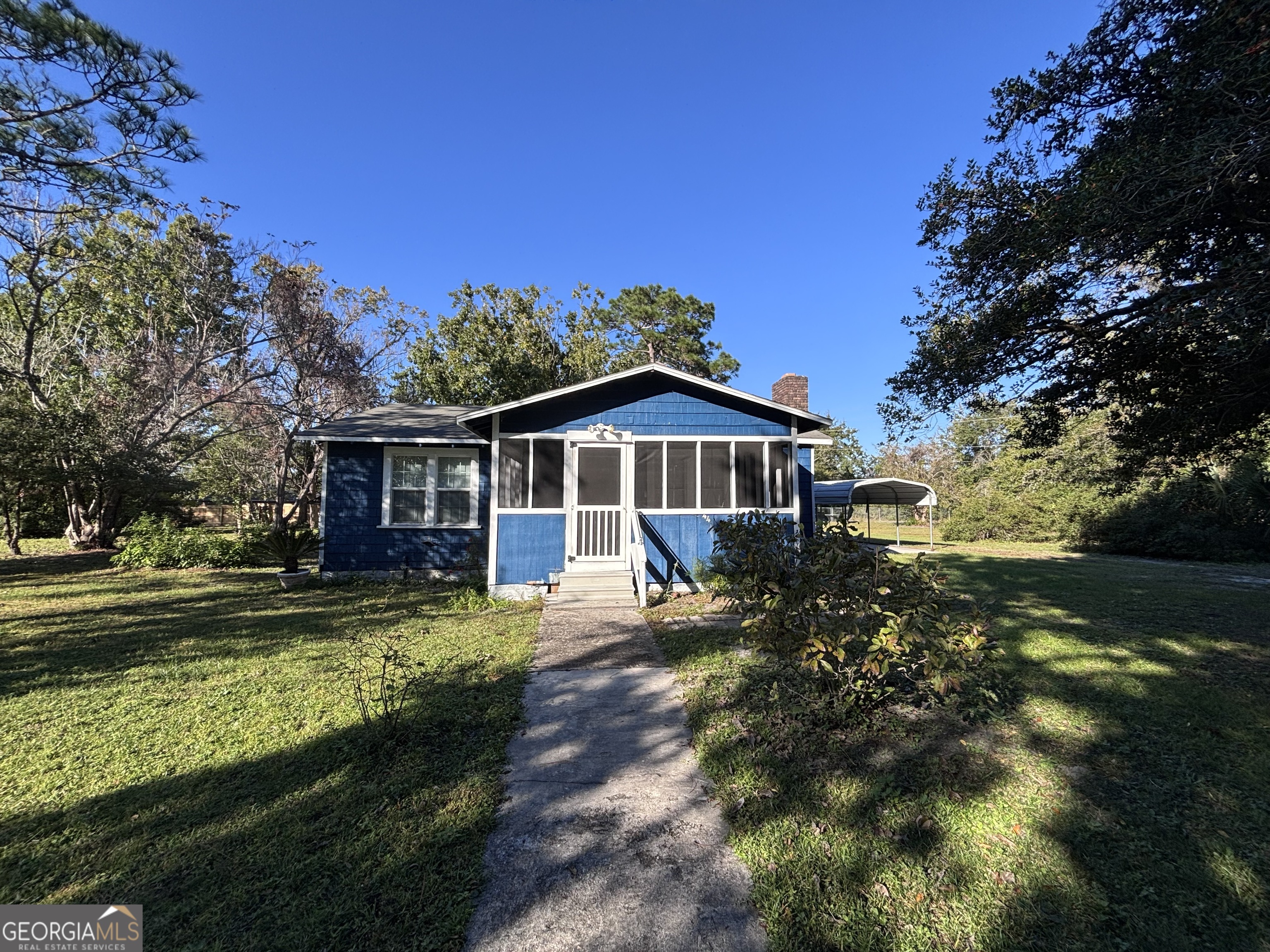 44 Olympic Lane St. Marys, GA 31558 - Photo 1 of 10 a front view of house with yard and green space