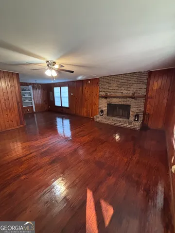 a view of a livingroom with a fireplace and window