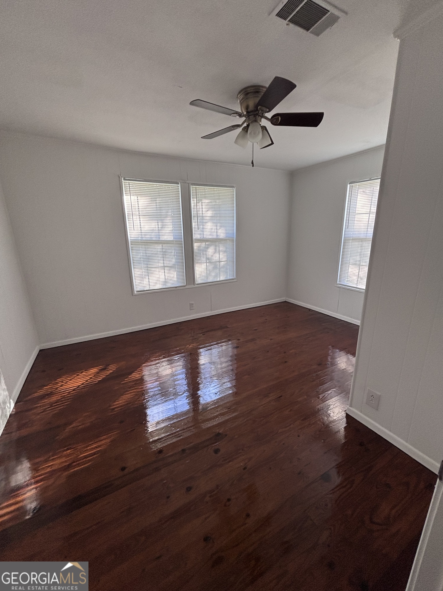 44 Olympic Lane St. Marys, GA 31558 - Photo 4 of 10 a view of an empty room with wooden floor and a window