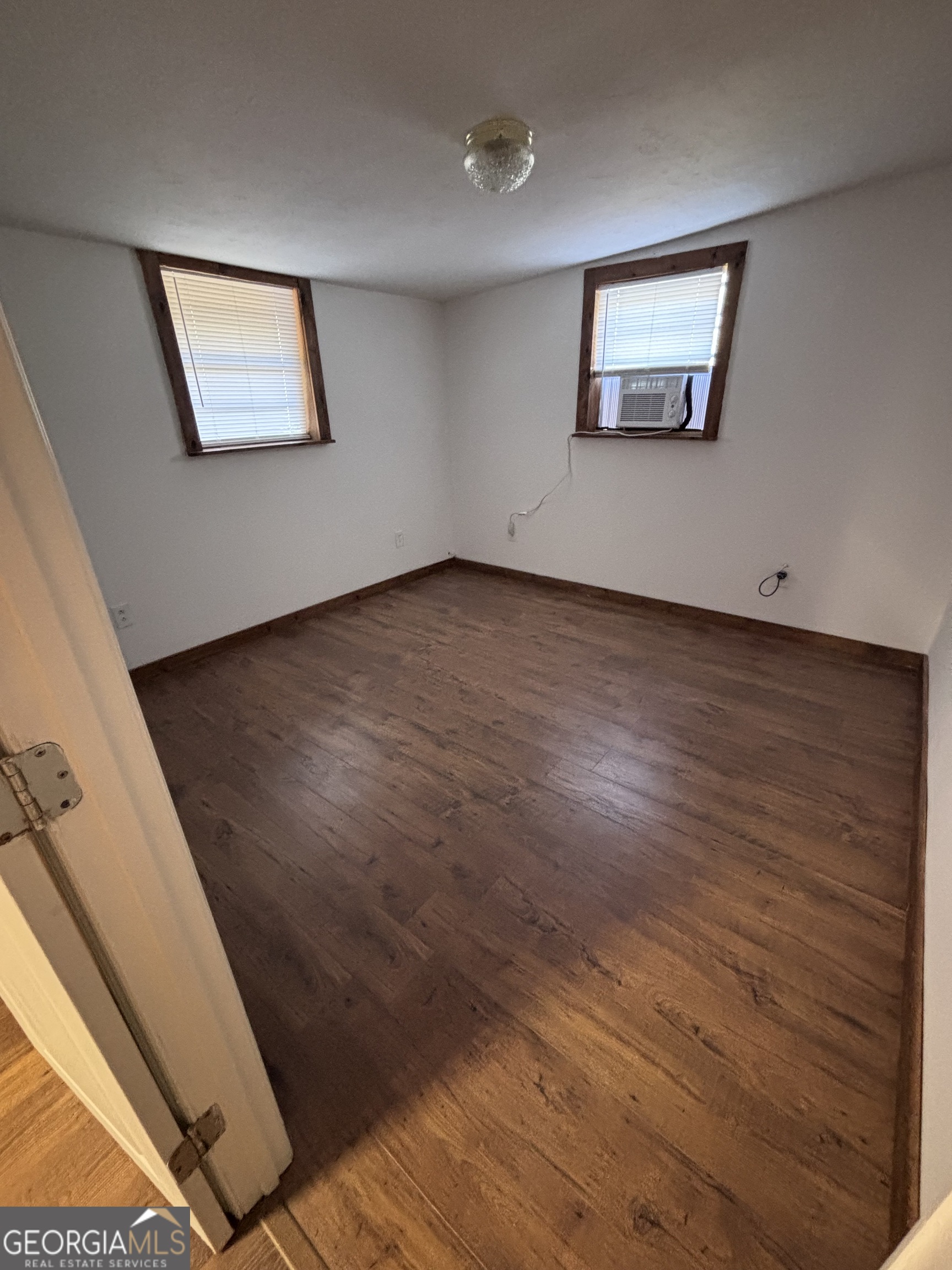44 Olympic Lane St. Marys, GA 31558 - Photo 9 of 10 an empty room with wooden floor and windows