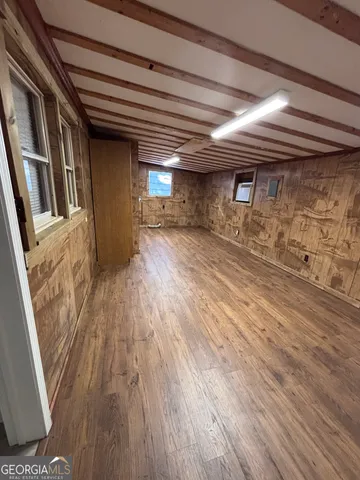 a view of an empty room and wooden floor