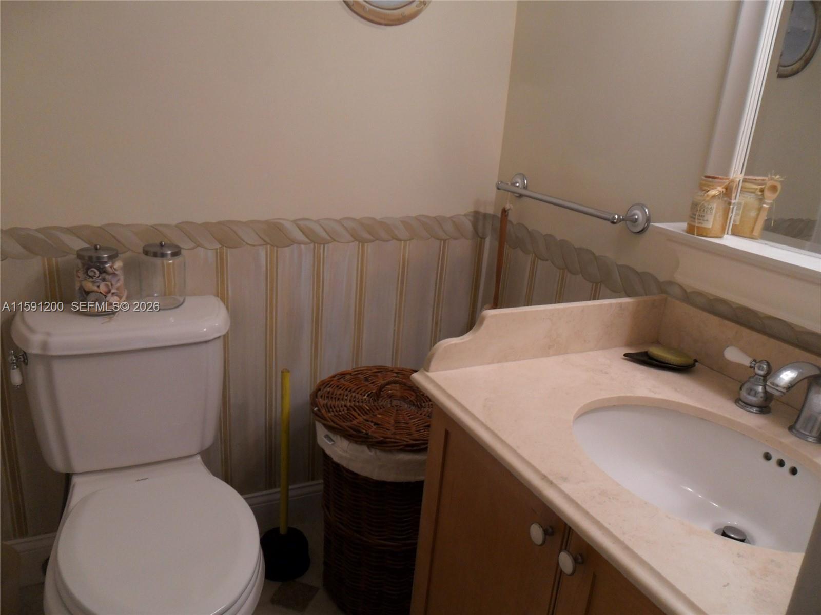 100 Lincoln Road, Unit 1434 Miami Beach, FL 33139 - Photo 6 of 29 a bathroom with a sink toilet and a mirror