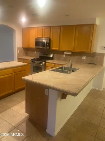 a kitchen with stainless steel appliances granite countertop a sink and cabinets
