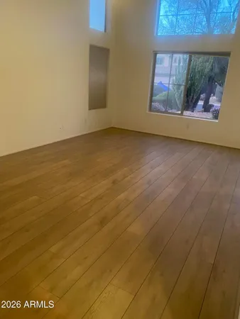 a view of an empty room with a fireplace and a window